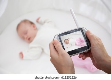 Hand Holding Video Baby Monitor For Security Of The Baby