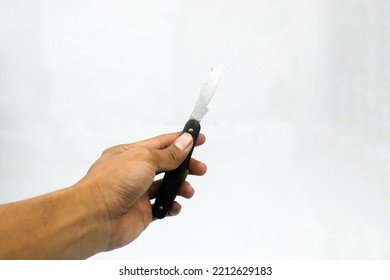 Hand Holding Vintage Sharp Kitchen Knife Isolated On White Background