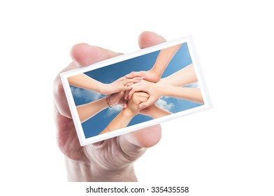 Hand Holding Volunteer Card With Joined Hands Background As Ngo Volunteering Concept