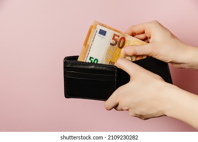  Hand Holding Wallet With Money, Euro In Hands. Euro Grows. 
Euro Is Devalued.