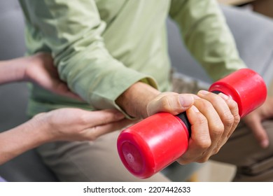 Hand Holding Weight Lifting Close Up, Senior People Doing Physical Therapy After Surgery Operation, Elderly Adult Exercising By Lifting Weights At Home, Medical Treatment Concept