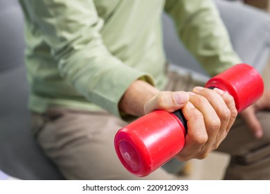 Hand Holding Weight Lifting Close Up, Senior People Doing Physical Therapy After Surgery Operation, Elderly Adult Exercising By Lifting Weights At Home, Medical Treatment Concept