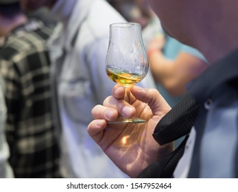 Hand Holding A Whisky Tasting Glass