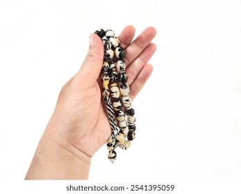 Hand holding white black tasbih or prayer beads isolated on white. - Powered by Shutterstock