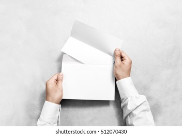 Hand Holding White Blank Envelope And Folded Leaflet Mockup, Isolated. Arm Hold Empty Brochure Template Mock Up. Greeting Card Flyer Design. Invitation Printing Display. Reading Writing In Envelope.
