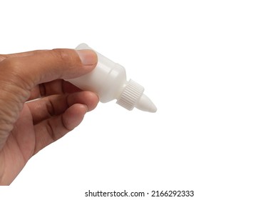 Hand Holding White Bottle Of Glue Isolated On White Background.