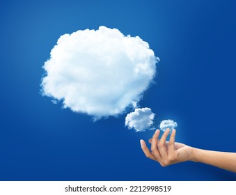 Hand Holding White Cloud Shape At Blue Background. Hand And Cloud Concept World Wide Data Sharing And Communication. 