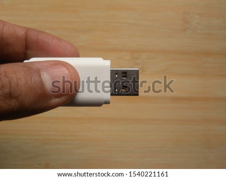 Hand holding white color USB flash pen drive