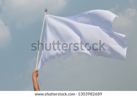 Hand up holding white flag pole the concept of give up. 