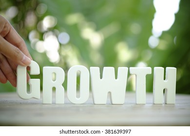 hand holding white letter GROWTH  text ,business concept ,business idea - Shutterstock ID 381639397