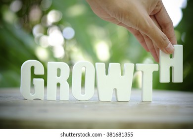 hand holding white letter GROWTH  text ,business concept ,business idea - Shutterstock ID 381681355