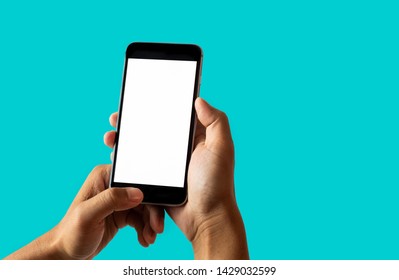 Hand Holding White Mobile Phone With Blank White Screen Dark Turquoise Background.