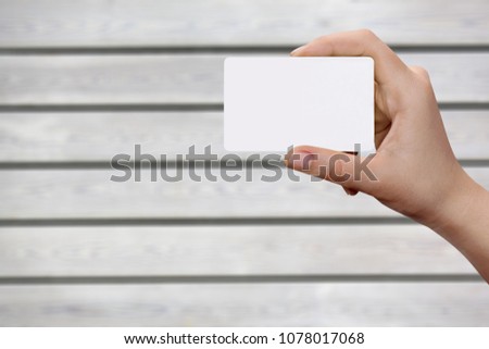 Hand holding a white note