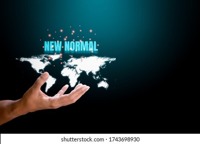 Hand Holding White World Map With Blue Text 'new Normal' And Orange Light On Blue And Black Technology Background. New Normal Concept.