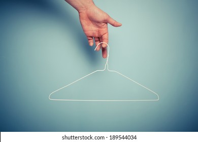 A Hand Is Holding A Wire Hanger