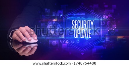 hand holding wireless peripheral with SECURITY UPDATE inscription, cyber security concept