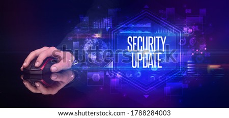 hand holding wireless peripheral with SECURITY UPDATE inscription, cyber security concept