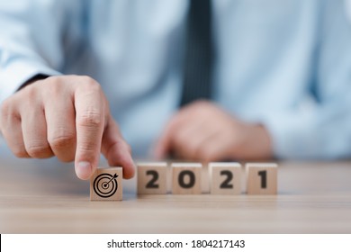 Hand Holding Wood Cubes With New Year 2021 And Goal Or Target Icon. Concept Of New Year Business Goals And Vision.