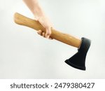 A hand holding a wood-cutting axe. The edge is covered with rubber guard. 