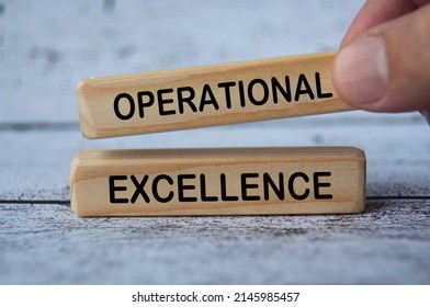 hand holding wooden block with text - Operational excellence. Business strategy concept