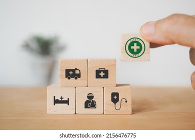 Hand Holding Wooden Cube Block With Safety First Sign And Stack Of Safety Icon  For Safe For Work Concept, Employees Safety Awareness At Workplace