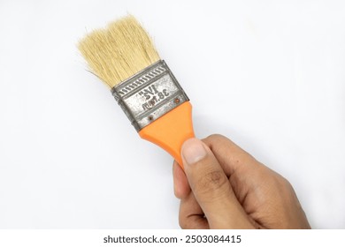 the hand is holding a wooden handle painting brush on a white background - Powered by Shutterstock