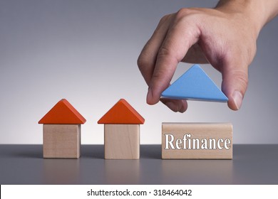 Hand holding wooden house (Housing Loan Concept) with word Refinance - Shutterstock ID 318464042