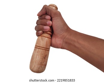 Hand holding a wooden pestle isolated on white background 