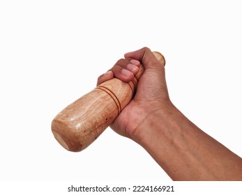 Hand holding a wooden pestle isolated on white background 