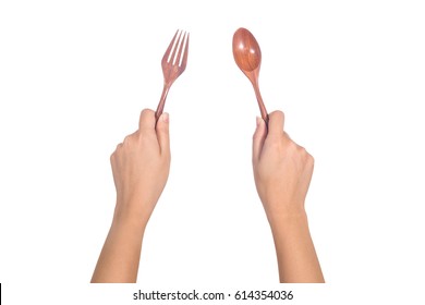 Hand Holding Wooden Spoon And Fork Isolated On White Background