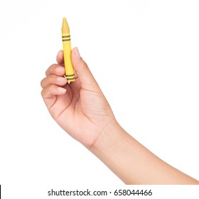 Hand Holding Yellow Crayon Isolated On White Background