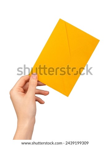 A hand holding a yellow orange envelope.isolated onwhite background