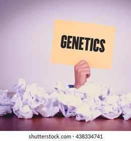 HAND HOLDING YELLOW PAPER WITH GENETICS CONCEPT