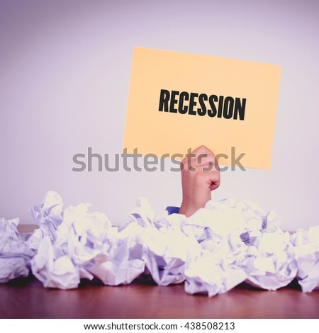 HAND HOLDING YELLOW PAPER WITH RECESSIONCONCEPT
