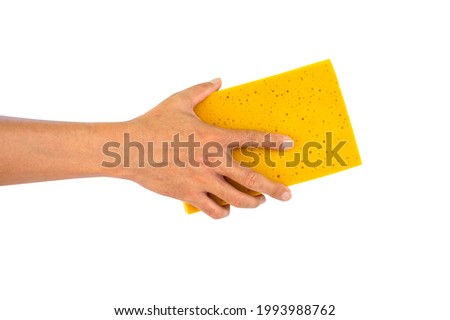 hand holding  yellow sponge isolated on white background