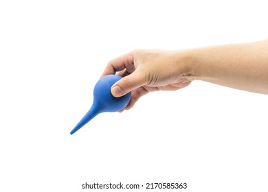 A Hand Holds A Blue Rubber Blowing Dust Ball Isolated On A White Background