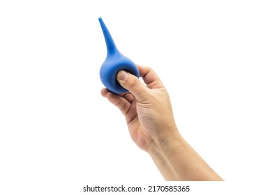 A Hand Holds A Blue Rubber Blowing Dust Ball Isolated On A White Background