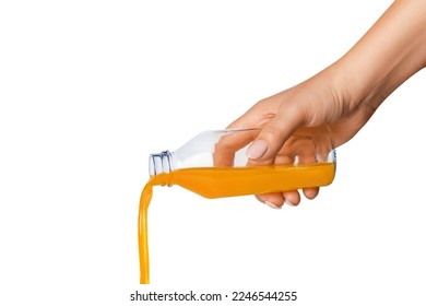 The hand holds a bottle of orange juice. Juice is pouring from a bottle. Isolated on white background. - Shutterstock ID 2246544255