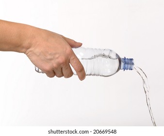 A Hand Holds A Bottle With Pouring Water