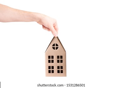 Hand Holds A Cardboard House Isolated On White Background