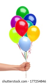 Hand holds colorful balloons isolated on white background