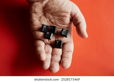 A hand holds computer keys that form the word "heart" with the letters H, E, A, R, T close-up, red background, the word "heart" from letters, long-distance relationships, hand and heart. - Powered by Shutterstock