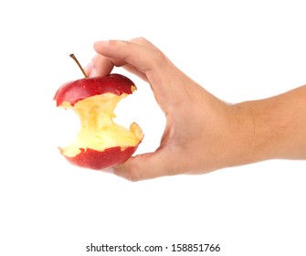 Hand holds core of an apple. Close up