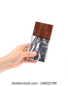 Hand Holds Dark Chocolate Bar In Foil.