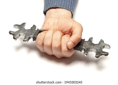 Hand holds firmly open-end wrench with metric and US standard on white background