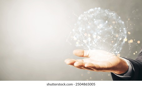 A hand holds a holographic sphere with interconnected nodes and lines on a light background, representing global data networking and technology concepts
