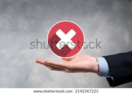 Hand holds icon,cancellation symbol,cancel icon.Cross mark flat red icon.round X mark.cancel button.Wrong.cross mark rejection.Declined.On dark background.Banner.Copy space.Place for text