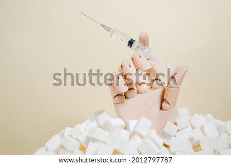 Hand holds insulin syringe. Diabetes awareness day.November 14. Insulin resistance. Sugar free.