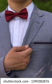 The Hand Holds A Jacket Lapel