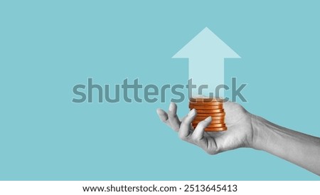 The hand holds a large stack of coins in her hand. Successful trading earning money, up arrow concept. Make more money